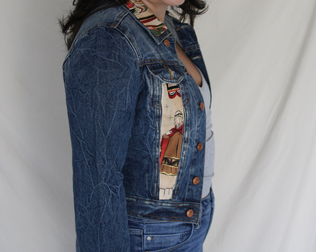 Handmade denim jacket featuring a vintage Catholic sewn into the center, repurposed from deadstock denim and designed for bold, sustainable streetwear. 