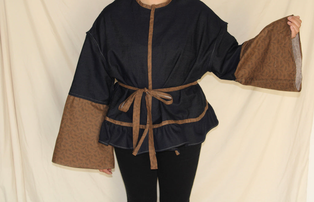 Handmade black and brown western jacket with oversized bellbottom sleeves crafted from up cycled fabric. sustainable, statement outwear with a dramatic silhouette and belted waist. 