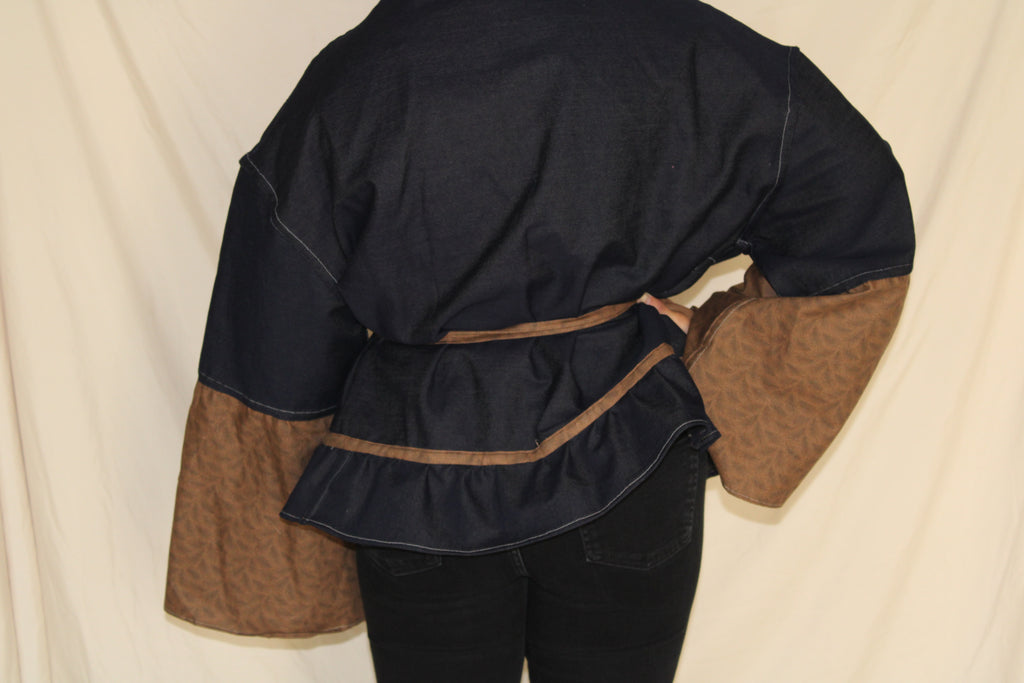 Handmade black and brown western jacket with oversized bellbottom sleeves crafted from up cycled fabric. sustainable, statement outwear with a dramatic silhouette and belted waist. 