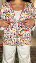 Handmade jacket featuring whimsical german scene. Trimmed in red gingham and finished with a playful front tie closure. Ethically sewn in the USA from rescued vintage cotton. Lightweight, breathable, and perfect for statement layering. 