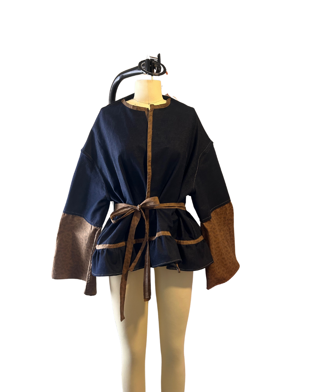 Handmade black and brown western jacket with oversized bellbottom sleeves crafted from up cycled fabric. sustainable, statement outwear with a dramatic silhouette and belted waist. 